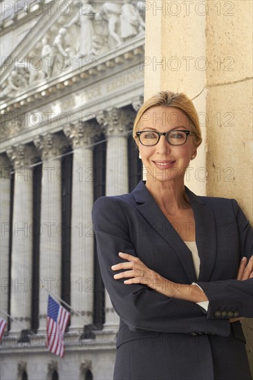 Caucasian businesswoman standing in city