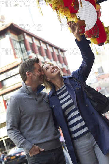 Caucasian couple shopping in Chinatown
