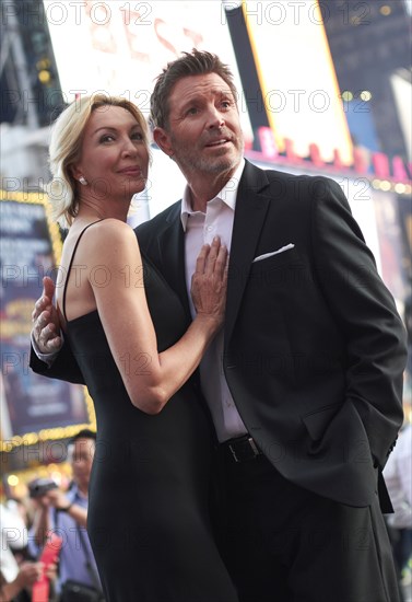 Caucasian couple hugging in Times Square