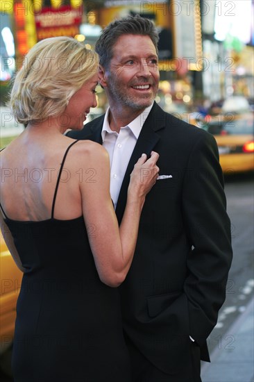 Caucasian couple hugging in Times Square