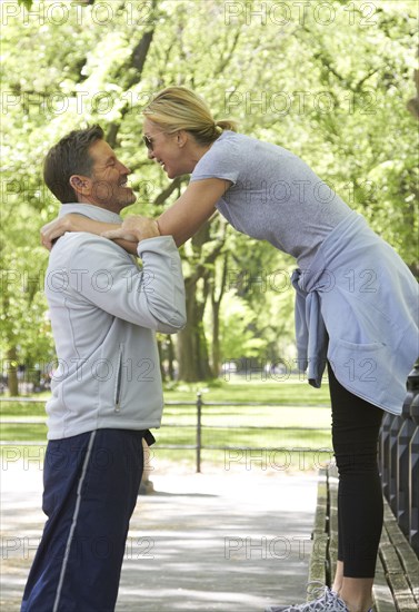 Caucasian couple playing in park