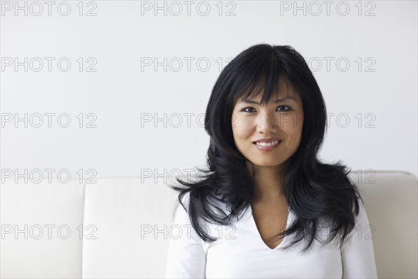 Smiling woman sitting on sofa