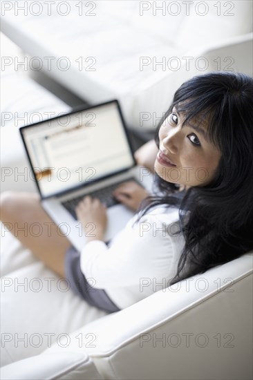 Woman using laptop in living room