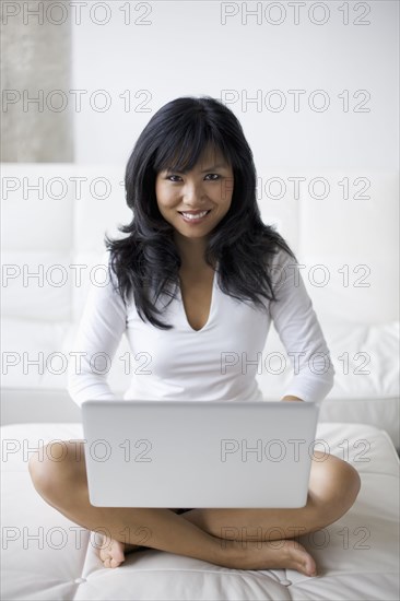 Woman using laptop in living room