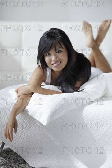 Smiling woman laying on bed