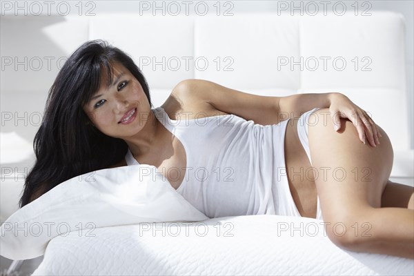 Smiling woman laying on bed