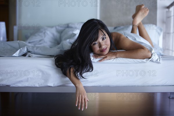 Smiling woman laying in bed