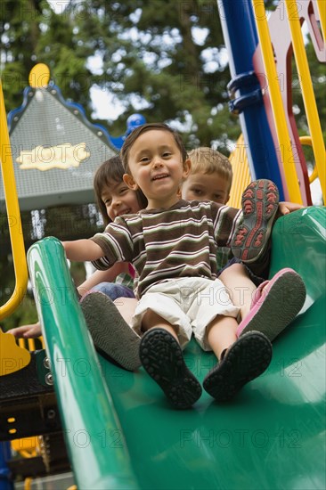 Children sliding in playground