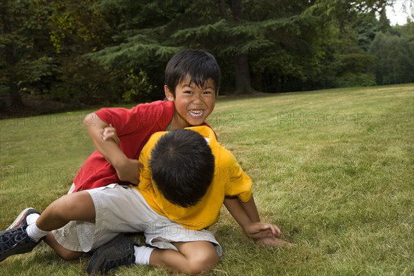 Asian boys playing in park