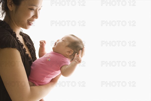 Chinese mother holding baby daughter