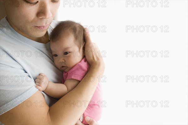 Chinese father holding baby daughter
