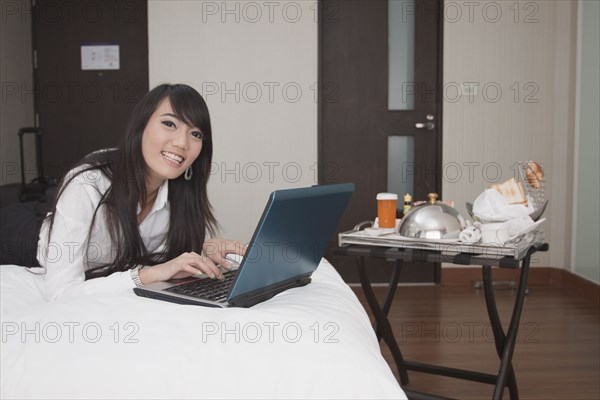 Asian businesswoman working in hotel room