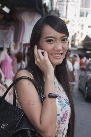 Asian woman talking on cell phone