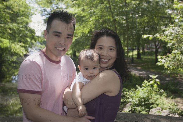 Chinese couple and baby in park