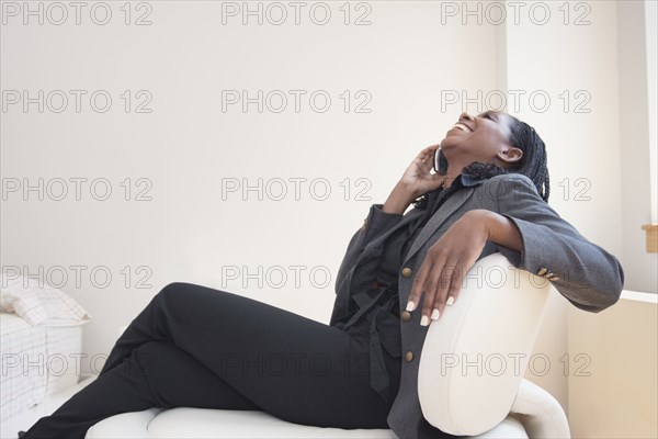 Mixed race businesswoman talking on cell phone