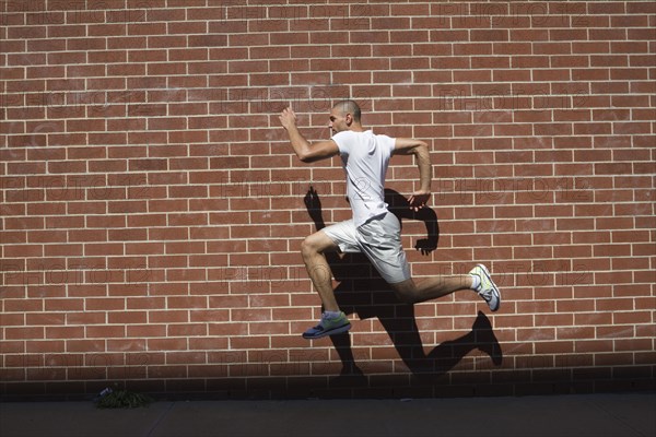 Mixed race athlete running in urban area