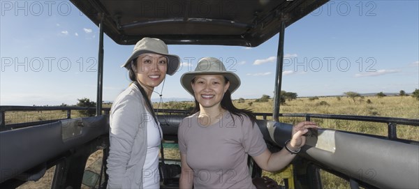 Women riding in truck on safari