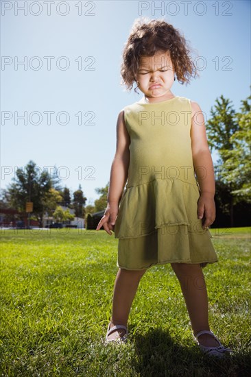 Mixed race girl crying in park