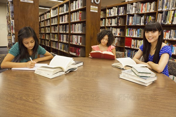 Girls doing homework in library