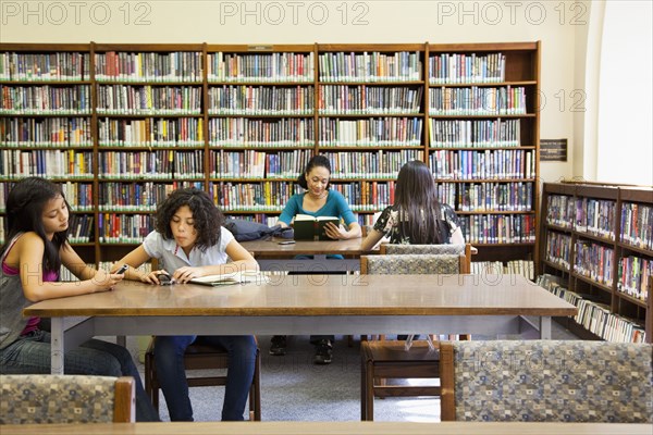 People reading books in library