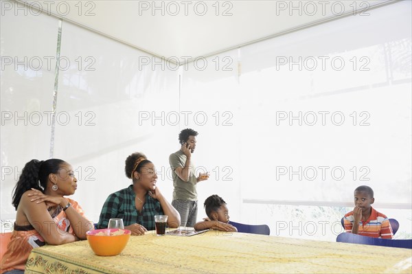 Black family eating at dining room table