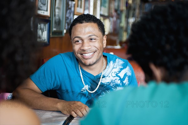 Smiling friends sitting in diner