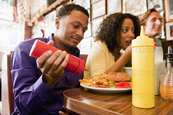 Friends eating in diner booth