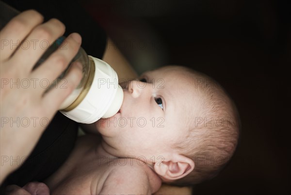 Close up of mother feeding newborn baby