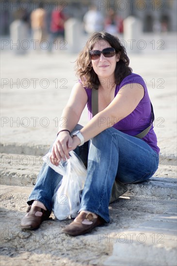 Caucasian woman sitting on steps