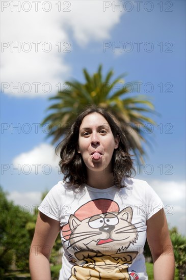 Caucasian woman sticking out tongue