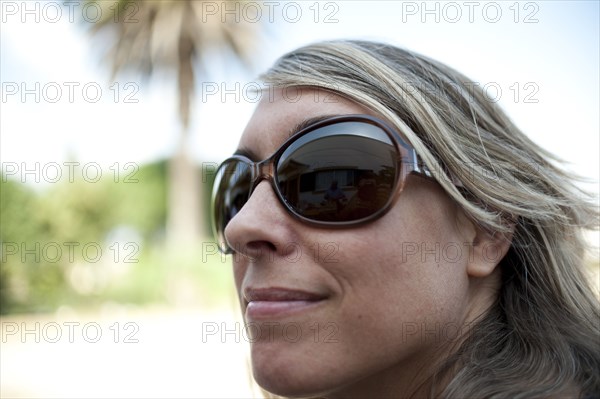 Smiling Caucasian woman wearing sunglasses