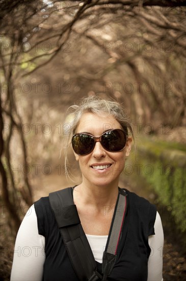 Caucasian woman in sunglasses standing outdoors