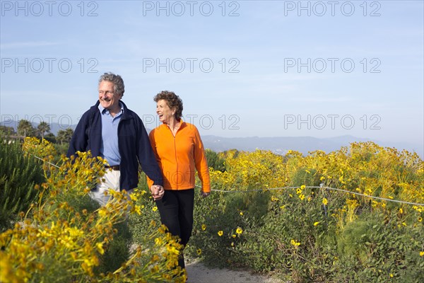 Caucasian couple walking on beach