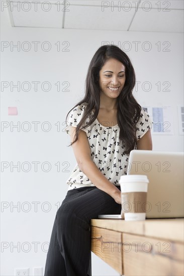 Businesswoman working on laptop in office