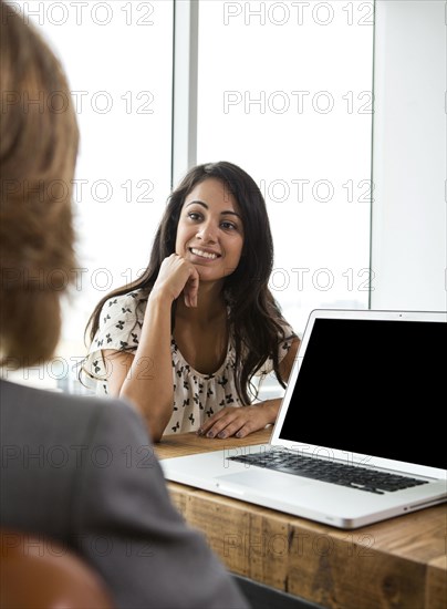 Businesswomen talking in office