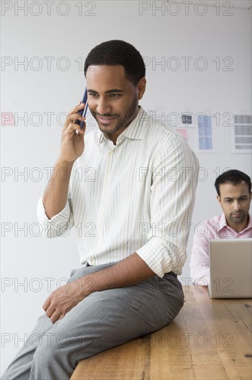 Businessman talking on telephone in office