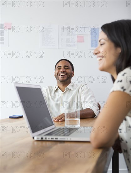 Business people laughing in meeting