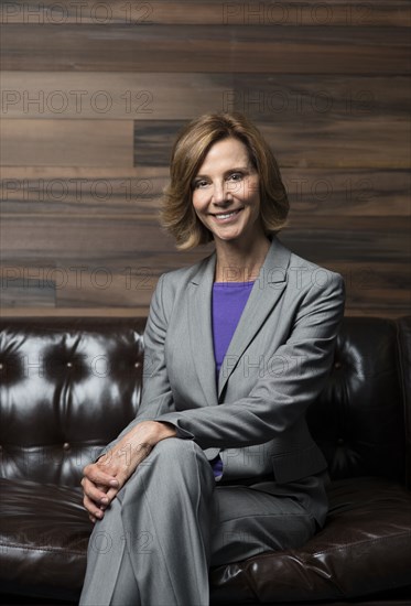 Caucasian businesswoman smiling in office