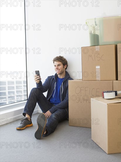 Caucasian man with cardboard boxes in new home