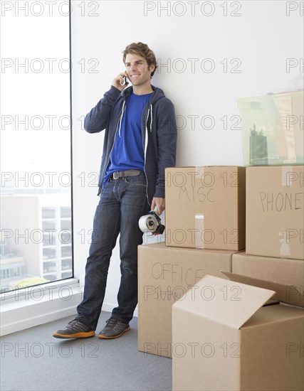 Caucasian man with cardboard boxes in new home