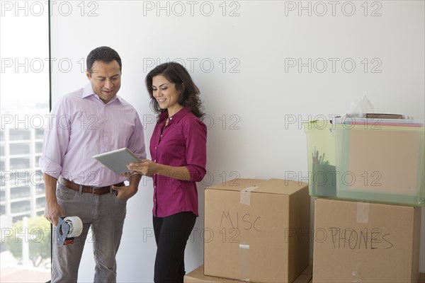 Business people using digital tablet in new office