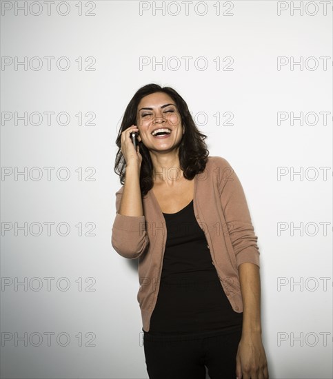 Mixed race businesswoman talking on cell phone