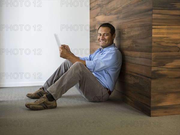 Hispanic businessman using digital tablet