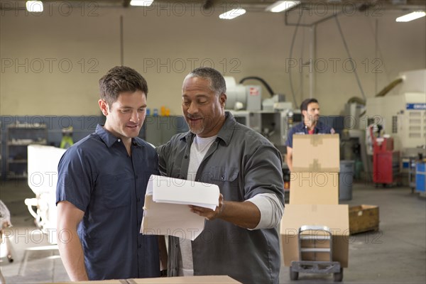 Workers talking in warehouse