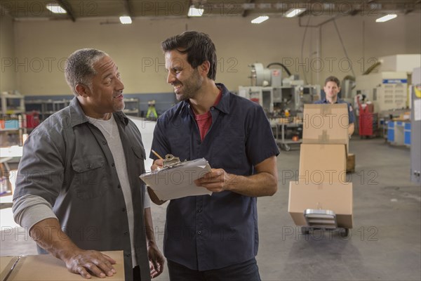 Workers talking in warehouse