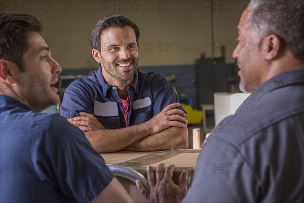 Workers talking in warehouse