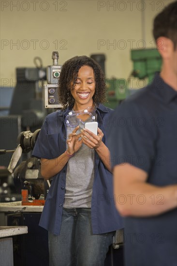 Worker using cell phone in warehouse