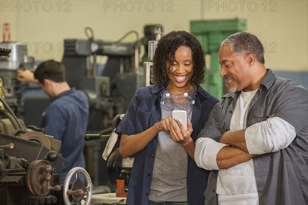 Workers using cell phone in warehouse