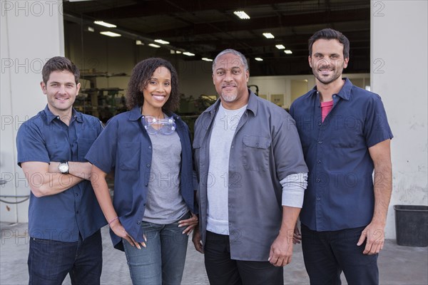 Workers smiling outside warehouse