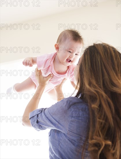 Mother playing with baby girl